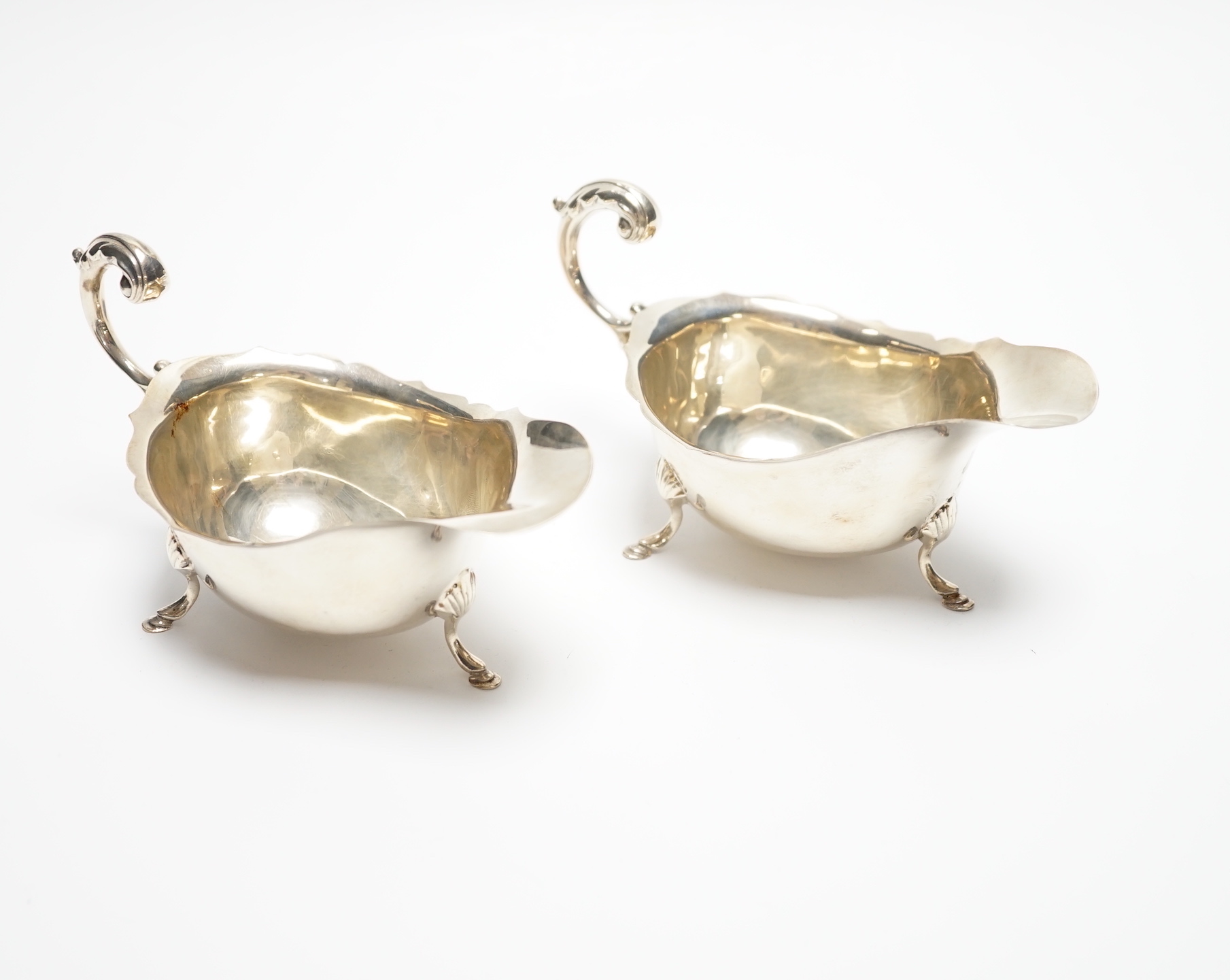 A pair of George V silver sauceboats, with flying scroll handles, S. Blanckensee & Sons Ltd, Birmingham, 1927, length 15cm, 4.7oz.